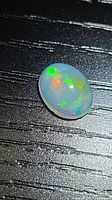 Top view of oval cabochon opal showing play-of-color