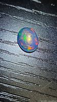 Top view of oval Ethiopian opal showing multicolour play-of-colour