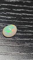Top view of oval opal showing play-of-color
