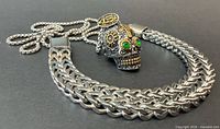 Necklace with skull pendant and bracelet side by side
