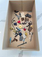 Overall view of box with mixed 1980s action-figure accessories