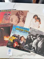 Group shot of six album covers on tabletop