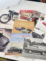 Top view of assorted automobile brochures spread on table