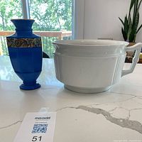 Blue vase and white ironstone pot side by side
