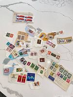Overview of assorted stamps and mint Canada Constitution strip