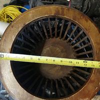 Top view showing slatted round basket top with tape measure across