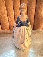 Front view of Royal Doulton Alison HN2336 figurine showing blue bodice and white floral skirt
