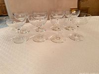 Front angled view of all eight etched coupe glasses