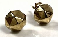 Front view of both gold studs showing faceted design