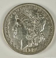 Obverse of 1880 Morgan silver dollar showing Liberty head and date