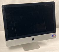 Front view showing screen, bezel, aluminum chin, and U.S. flag sticker