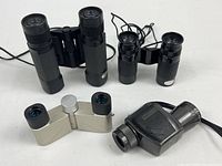 Group shot of three binoculars and one monocular