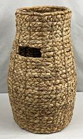 Full view of tall woven basket showing overall shape and weave