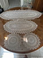 Full view of runners and doilies on table
