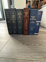 Front view of all six hardcover legal volumes upright