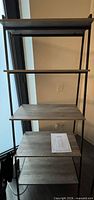 Full view of bookcase showing five shelves and metal frame