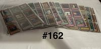 Stack of binder pages filled with Yu-Gi-Oh! cards