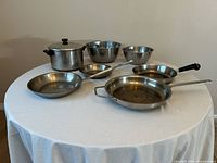 Full view of all seven stainless pieces on table