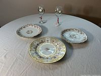 Overview of three plates and two wine glasses on table