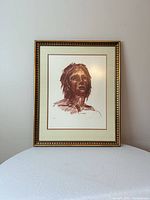 Framed sepia portrait lithograph on table showing full view