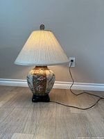 Full view of lamp lit with shade and cord