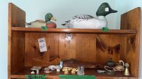 Shelf view showing both large wood duck decoys on upper shelf and all smaller items on lower shelf