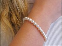 Cream pearl bracelet worn on wrist, shows bead size and luster