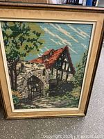 front view of framed needlepoint artwork