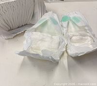 open diapers showing inner material and wetness strip
