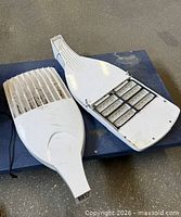 Both LED street light fixtures, top view showing heat sink on one and LED modules on the other