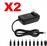 Two identical 12 V adapters with plug tip set shown