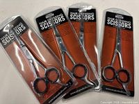 Four sealed pairs of hairdressing scissors in blister packs