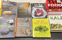 All eight cookbooks laid out, front covers visible