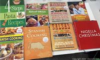 All eight cookbooks laid out showing front covers