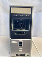 Front view of tower showing optical drive, missing bay cover and Amsdell badge