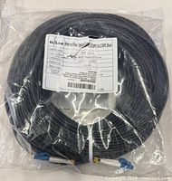 Coiled armored fibre optic cable in sealed bag, full view