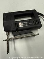 Full view of Black & Decker jig saw showing body, base plate and blade