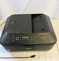 Front and top view of Canon PIXMA printer showing control panel, LCD, buttons and USB power cable