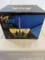 Retail box front showing Easy Lite Cleo 3-light chandelier image and branding