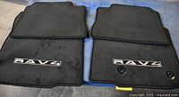 Front view of two logo front mats showing embroidery and grommets