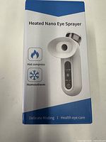 Front view of boxed heated nano eye sprayer showing product image and features