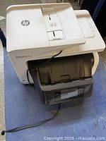 Three-quarter top view showing overall printer form, color scheme, ADF and power cable