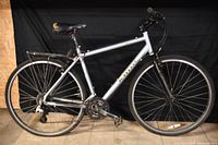 Full left side view of bicycle showing frame, wheels, rack