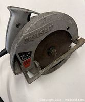 Left profile of Skilsaw circular saw showing full tool