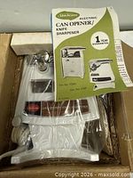 Appliance sealed in plastic with instruction manual visible inside original carton