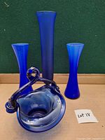 front view of two bud vases, tall vase, and basket