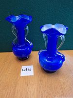 Front view of both cobalt blue bud vases showing color, shape, handles
