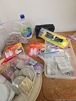 Overview showing rope package, Command hook packs, furniture pads, radio, water bottle (not listed)