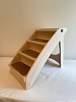 Front-side view of beige four-step pet stairs