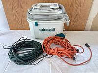 Steamer with both extension cords grouped together